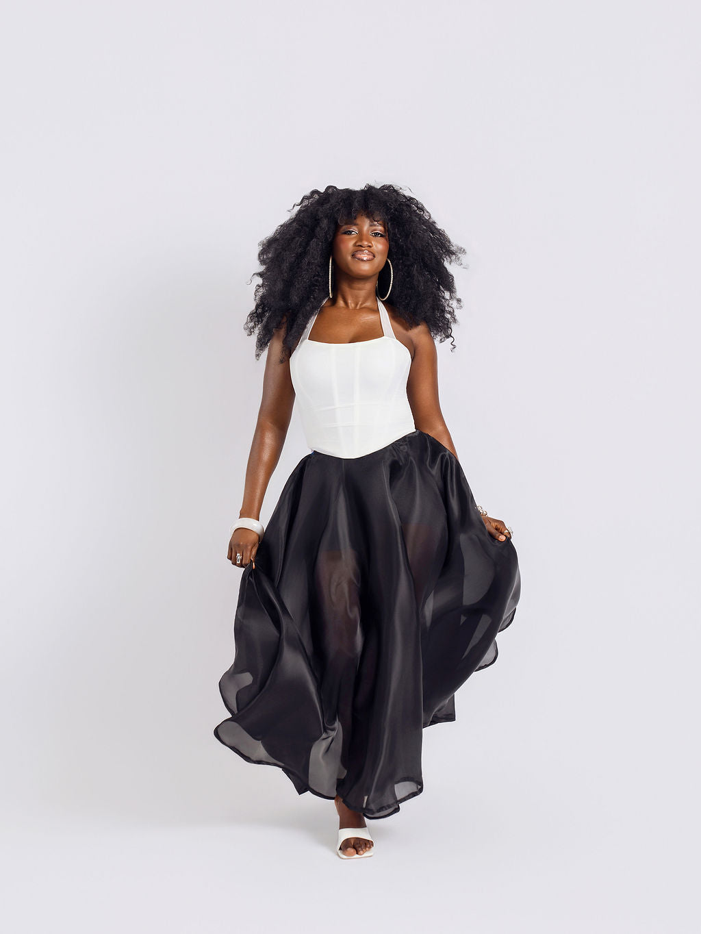 Front-view of a model wearing Amazin Apparels unlined black organdy maxi skirt 