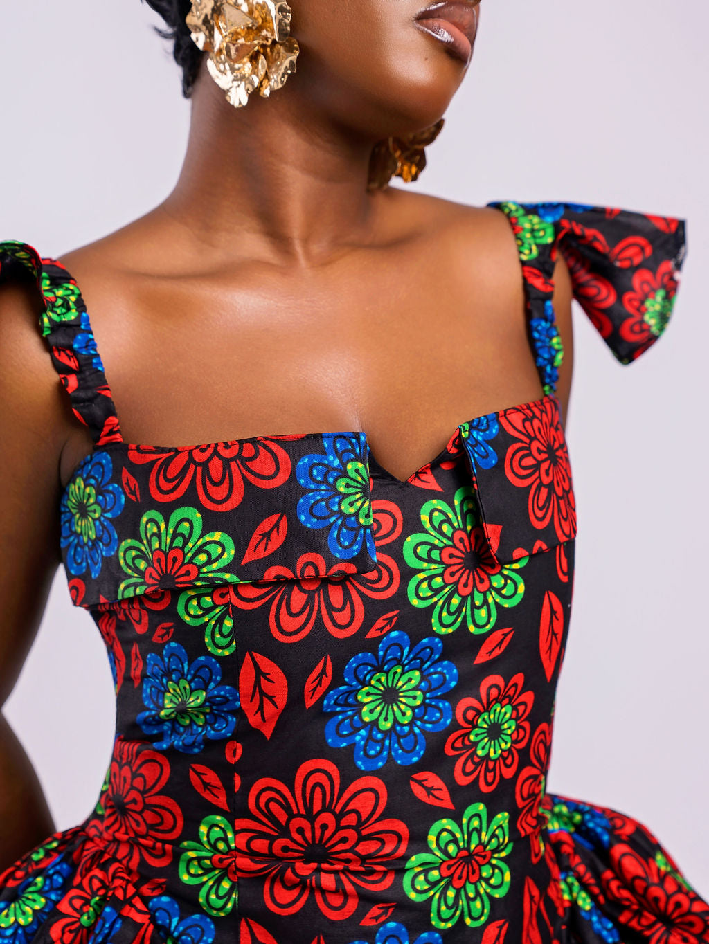Close-up showing the straight neckline with small V-cut and stylish folded details