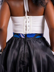 Close up back view of a model wearing the sheer, unlined black organdy maxi skirt with both hand in the pockets, showing the zip. 