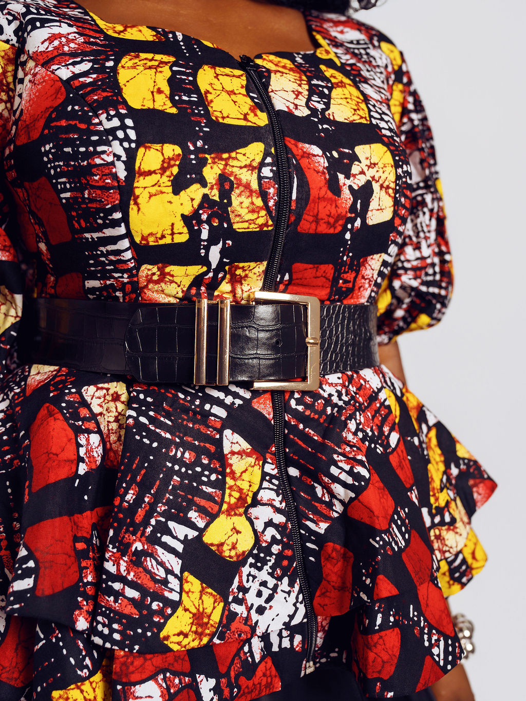Close-up Front-view of a model wearing the Seyi Ankara Peplum Top 