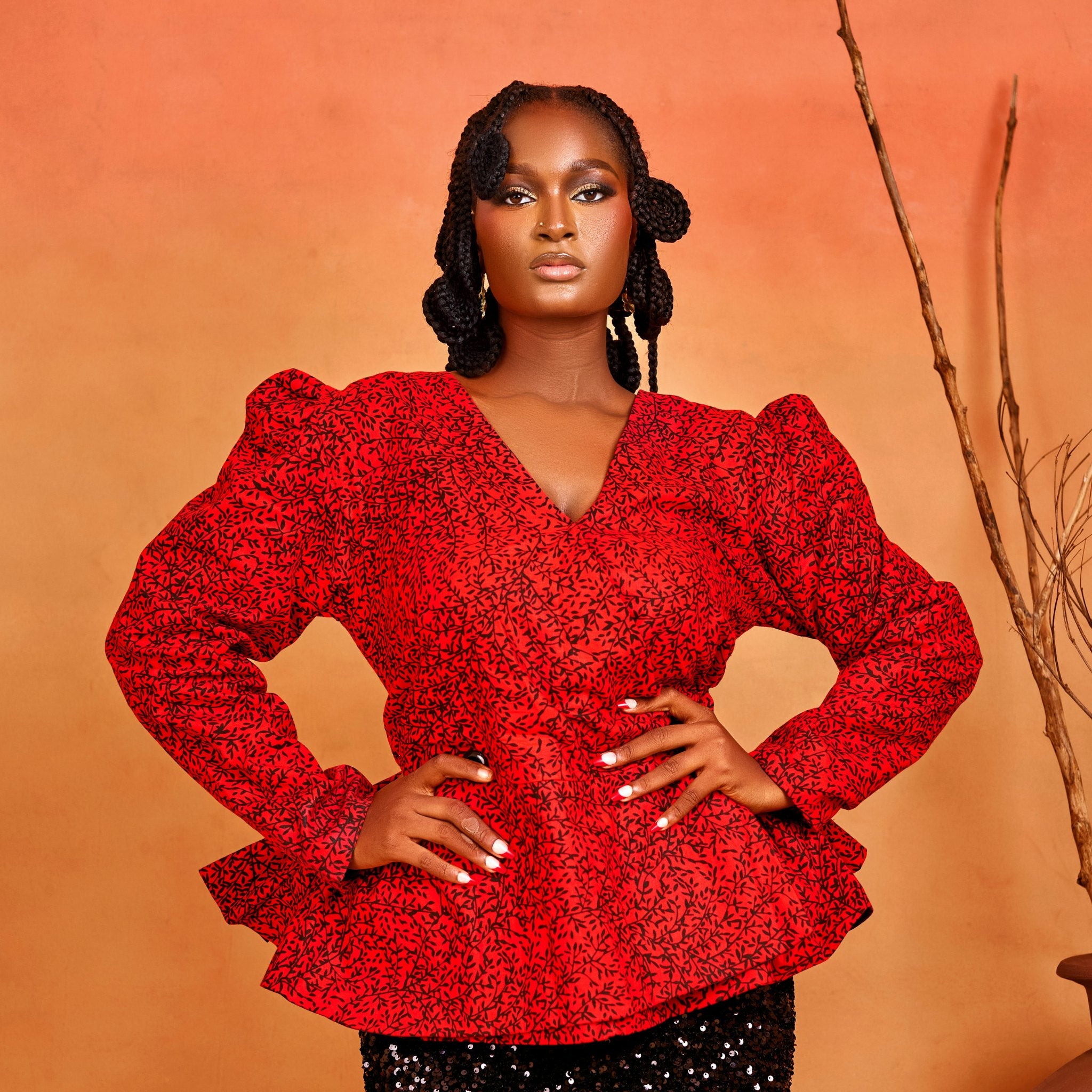 wrap peplum blouse of the Ìfẹ́ Set, featuring red Ankara fabric