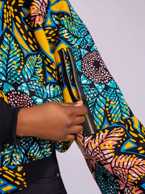 Close-up of the left sleeve on the Sunflower Bomber Jacket showing the functional gold-toned utility zipper pocket and ribbed cuff.