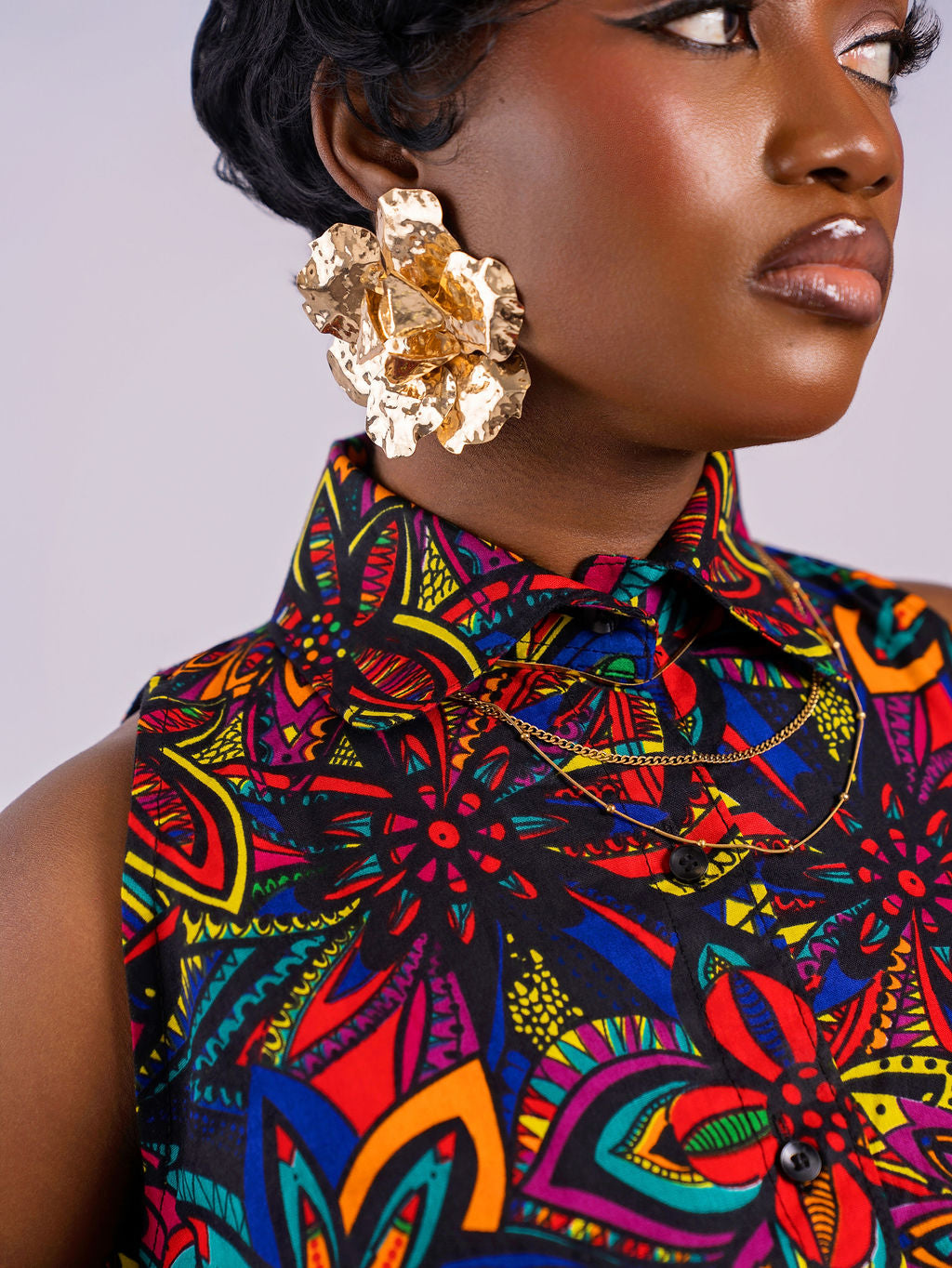 Detailed close-up of the high pointed shirt collar and button-down front of the floral Kaleidoscope Gown by Amazin Apparels.