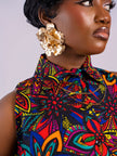 Detailed close-up of the high pointed shirt collar and button-down front of the floral Kaleidoscope Gown by Amazin Apparels.
