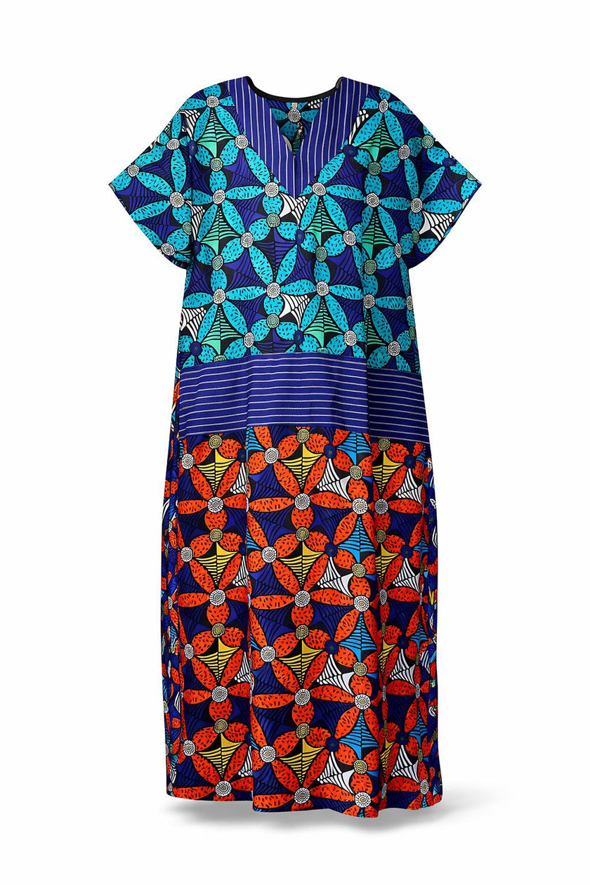 front view of the Amazin Apparels Aso Oke Fusion Gown, featuring a blue pinstripe top with v-neck, bold floral skirt, and floor-length shredded Aso Oke fringe on the sides coming from the waist division made of authentic textured Aso Oke fabric on a multi-patterned maxi dress.
