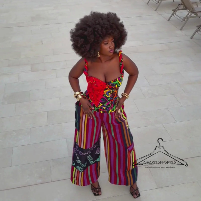 Video of model dancing gracefully while giving a 360-degree view of the Ànìké Ankara corset blouse. The bustier features a sweetheart neckline, braided straps, structured silhouette, padded bust, and lace-up back. Made from vibrant multicoloured African print heart-patterned cotton, this corset top blends cultural elegance with modern fashion, perfect for weddings, cultural celebrations, cocktail parties, and evening occasions.